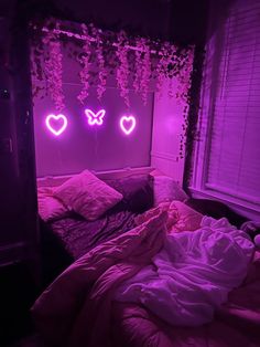 a bed in a room with two neon lights above it