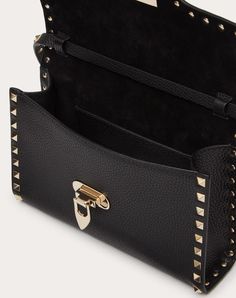 Small Valentino Garavani Rockstud grainy calfskin crossbody bag. - Platinum-finish metal studs and hardware - Hook closure - Adjustable shoulder strap - Interior: open slip pocket - Dimensions: W22.5xH15xD6 cm / W8.9xH5.9xD2.4 in. - Made in Italy Patches Fashion, Black Stud, Bottega Veneta Shoulder Bag, Crossbody Bag Women, Small Crossbody Bag, Small Crossbody, Small Shoulder Bag, Handbag Accessories, Shoulder Bag Women