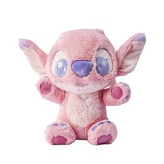 a pink stuffed animal with blue eyes and ears