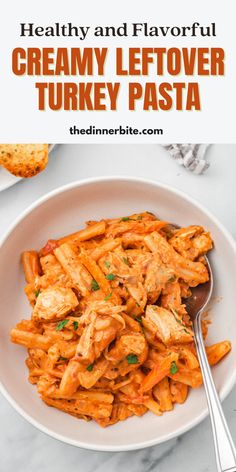 a white bowl filled with creamy leftover turkey pasta