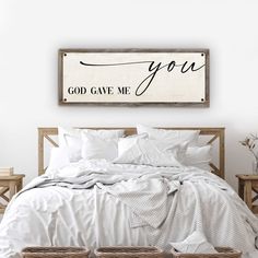 a bed with white sheets and pillows in a bedroom next to two baskets on the floor