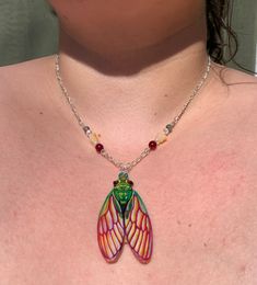 The Rainbow Cicada necklace is a wearable piece of art. Drawn on buffed plastic and then coated with resin, each piece is handcrafted from start to finish by the artist. The silver chain is accentuated by colorful bead embellishments and is joined by barrel screw clasps. Each necklace is roughly 16" long. Cicada Necklace, Handmade Jewlery, Silver Chain, Embellishments, Favorite Jewelry, Necklace Etsy, Jewelry Necklace Pendant, Handmade Items, Rainbow