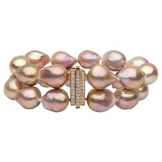 This hypnotic bracelet by Yoko London features two rows of unique, pink baroque pearls. Each baroque pearl is completely unique and this design perfectly highlights their allure and mystique. The rich, pink hues of the pearls are perfectly offset by the 18 Karat Rose Gold and diamond clasp. This striking bracelet will add a unique finish to any outfit. -12.5-14.5mm Freshwater Baroque Pearls - 33 Diamonds (Total Carat Weight: 0.84ct) - 18 Karat Rose Gold - Length: 19.5cm/7.5 inches Luxury Beaded Rose Gold Jewelry, Luxury Rose Gold Beaded Jewelry, Luxury Pink Pearl Bracelet With Round Beads, Luxury Pink Elegant Pearl Bracelet, Luxury Pink Baroque Pearl Necklace, Luxury Pink Baroque Pearl Necklaces, White Diamond Pearl, Pink Baroque, Modern Bangle