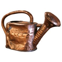 a metal teapot with a handle on it