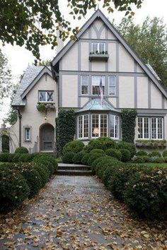 a large house with lots of windows and bushes