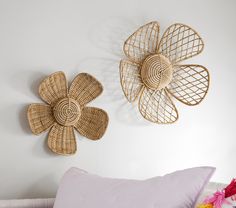 two wicker flower wall hangings on the wall