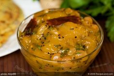 a glass bowl filled with food on top of a wooden table