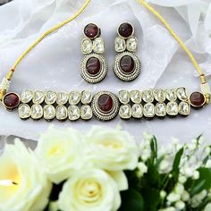 The Tayani Kundan necklace features a stunning Red Ruby stone adorned with intricate AD stones and Paired with long, lightweight earrings, it exudes elegance and charm, making it a statement piece for any occasion. necklace adjustable (backside an adjustable coard) push back earrings Choker Necklace Indian, Kundan Bracelet, Indian Choker Necklace, Necklace Set Indian, Necklace Indian, Indian Necklace, Moissanite Necklace, Kundan Necklace, Necklace Wedding