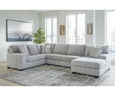 a living room with a sectional couch and rug