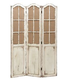 an old white wooden room divider with glass doors on the front and back sides