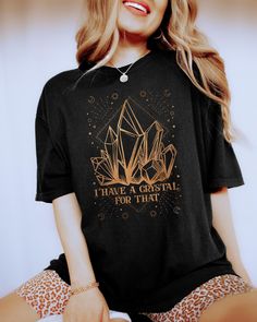 PLEASE NOTE, DUE TO THE BUSY HOLIDAY SEASON ANY ORDERS PLACED AFTER 12/09/24 ARE NOT GUARANTEED TO ARRIVE BY CHRISTMAS.This Comfort Colors Tshirt features the saying I Have A Crystal For That and a beautiful mystical design.  This T-shirt would make the perfect gift for the spiritual person in your life. Comes in multiple colors! ✨️SIZE AND FIT: Your shirt will be printed on a high-quality, soft and comfortable unisex t-shirt. Sizes run true to size, which takes the guesswork out of ordering. If Spiritual Outfits, Crystal Shirt, Spiritual Person, Magic Clothes, Spiritual Clothing, Mystical Moon, Spiritual Shirts, Comfort Colors Tshirt, Moon Shirt