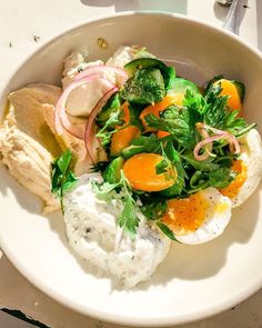 a white bowl filled with food on top of a table