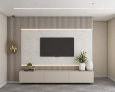 a modern living room with a flat screen tv on the wall and two vases