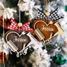 two wooden ornaments hanging from a christmas tree with the name jesus and hair stylist