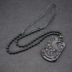 This exquisite hand-carved black obsidian pendant necklace depicts an ancient immortal Phoenix with her brood, signifying longevity, rebirth and renewal. Obsidian is said to be able cleanse negativity and encourage positive energies. Combined with the mystical Phoenix, this necklace is a meaningful gift for any loved one. Material: Natural Black Obsidian, Waxed Cord Chain, Beads Pendant Size: 6.5 x 4.2 x 1.0 cm (2.3" x 1.5" x 0.4") Necklace Length: 60 - 72cm (23.6" - 27.6") Adjustable Cord Click ADD TO CART To Order Yours Now! The Checkout Process is Guaranteed to be 100% Safe and Secure with Visa, Mastercard, AMex, Discover, Apple Pay or PayPal. Phoenix Necklace, Beads Pendant, Black Obsidian, Beaded Pendant, Meaningful Gifts, Dog Tag Necklace, Phoenix, Necklace Lengths, Hand Carved