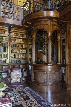 a large wooden room with many bookshelves and furniture in it's center