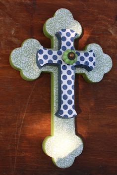 a wooden cross with polka dots on it