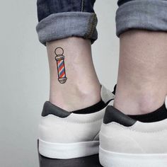 a person with a small tattoo on their ankle