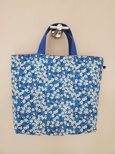 "From the world famous Liberty Fabrics Augusta Linen Mitsi Blue. 55% Linen / 45% Cotton. Lightweight. This bag is great size for a couple of children's items and good for daycare bag. Size is 14.1\"W / 11\"H / 3.1\"D (36cm / 29cm / 8cm) Flat bottom shape. Fabric is Liberty Fabrics Augusta Linen. It comes with a velvet ribbon on one side.(color is blue) Lined inside with pretty red color cotton. Please, Hand wash. Or cool brilliantly on a machine hand wash. All my works are carefully handmade in Blue Medium Everyday Bag, Medium Blue Everyday Bag, Everyday Medium Blue Bag, Cotton Shopping Bag With Rolled Handles, Cotton Shopping Bags With Rolled Handles, Blue Canvas Beach Bag For Shopping, Cotton Tote Bags With Rolled Handles, Large Blue Beach Bag For Everyday Use, Large Capacity Rectangular Diaper Bag For Shopping