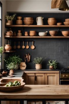 a kitchen filled with lots of pots and pans on top of wooden shelves next to a window