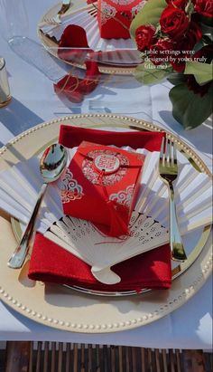 the table is set with red napkins and silverware