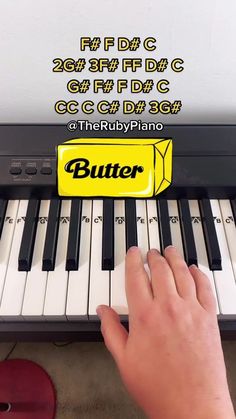 a person is playing the keyboard with a butter stick in front of it that says butter