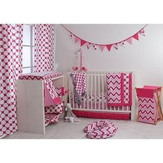 a pink and white crib bedding set in a child's room with curtains