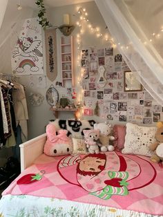 a bedroom with pink and white bedding, teddy bears and pictures on the wall