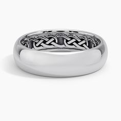 a wedding ring with an intricate design on the center and sides, in white gold