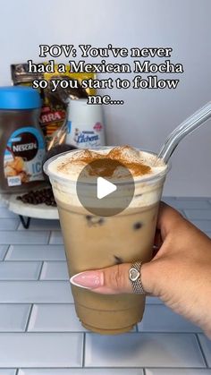 a person holding a cup of coffee with the caption pov you've never had a mexican mocha so you want to follow me