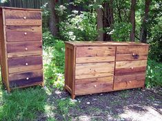 two wooden dressers sitting next to each other on the grass in front of trees