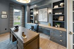 a home office with gray walls and wooden floors