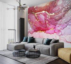 a living room with a large painting on the wall next to a couch and coffee table