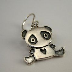 Sweet solid sterling silver Panda earrings to last a lifetime!  They are 1/2 of an inch tall and made completely from sterling silver with solid sterling French ear wires. Adorable!To see all my sterling silver charm earrings go here:https://www.etsy.com/shop/marmar?ref=hdr_shop_menu&section_id=5064601For the large matching necklace:http://www.etsy.com/listing/94186350/panda-bearFor the small matching necklace:http://www.etsy.com/listing/91509033/baby-panda-necklaceFor the mother-daughter se Handmade Sterling Silver Dangle Charms, Cute Silver Earrings For Anniversary, Sterling Silver Hypoallergenic Pendant Earrings, Small Nickel-free Sterling Silver Charms, Handmade Sterling Silver Charms In Silver, Pendant Earrings With Charms For Gift, Sterling Silver Drop Earrings With Charms, Small Sterling Silver Jewelry With Charms, Sterling Silver Jewelry With Charms