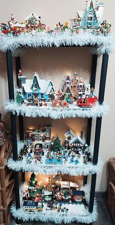 a three tiered shelf with christmas decorations on it