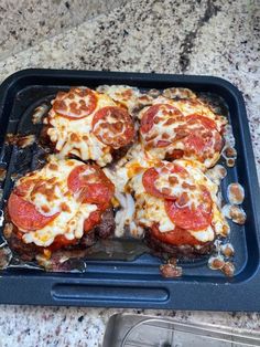 four slices of pizza sitting on top of a pan covered in cheese and pepperoni