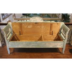 an old wooden bench sitting on top of a hard wood floor