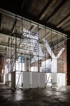 an empty room with scaffolding on the walls and stairs in front of it