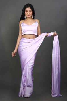 This Satin One Minute Saree in Lavender makes for the perfect Bridesmaid Saree! The satin material drapes like a dream and it's paired with a monochromatic lavender satin blouse which is perfect for traditional, festive or party occasion.Product Features: Saree Type: Ready to wear, Pre-stitched, Pre-draped Saree Saree Color: Lavender Blouse Color: Lavender Saree Fabric: Satin Blouse Fabric: Satin Shoulder Drape: Customer must select the shoulder drape style while ordering Work: None Occasion: Pa Festive Lavender Saree With Traditional Drape, Traditional Lavender Pre-draped Saree For Festive Season, Fitted Lavender Saree, Semi-stitched Lavender Saree For Festivals, Lavender Satin Saree, Orange Hijab, Lavender Blouse, Bridesmaid Saree, Satin Saree