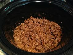 a crock pot filled with food sitting on top of a counter