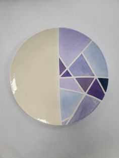 a white plate with purple and blue designs on it