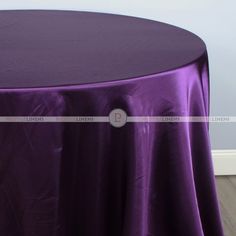 a round table with a purple cloth on it