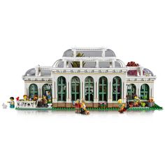 a lego model of a building with people standing in front of it on a white background