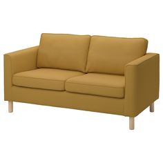 a tan couch with two pillows on top of it's back legs and arms