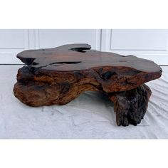 a large wooden table sitting on top of a white sheet