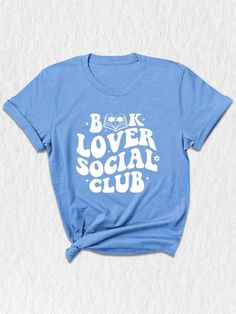 Introducing our exclusive Social Club Bookish T-Shirt, a must-have for all bookworms and avid readers! ✨ Perfect for book club enthusiasts and lovers of literature, this unique design merges style and intellect to create a statement piece for any occasion. Our social club shirt features a captivating illustration that brings together various elements of the bookish world.  The center focuses on a charming library, adorned with piles of books and a cozy reading chair. Surrounding it, adorable emo Bookish Shirt Designs, Book Club Shirt, Belles Book Club Shirt, Bookish Graphic Print T-shirt For Summer, Cozy Reading Chair, Summer Bookish T-shirt With Graphic Print, Bookworm Shirt, Happy Shirt, Librarian Shirt