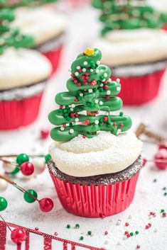 cupcakes decorated with green frosting and a christmas tree on top