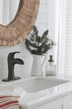 a bathroom sink with a mirror above it and a towel on the counter next to it