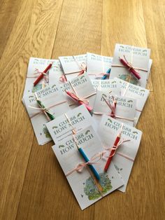 small cards with ribbons tied to them on a wooden table