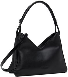 Grained leather shoulder bag in black. · Knotted detailing at hand-wrapped fixed carry handle · Adjustable and detachable crossbody strap · Logo embossed at face · Zip closure · Patch pocket at interior · Moiré lining · Logo-engraved silver-tone hardware · H7 x W10 x D3 Supplier color: Black Formal Black Staud Shoulder Bag, Staud Shoulder Bag With Adjustable Strap, Staud Black Bag With Detachable Strap, Luxury Black Staud Bag, Black Staud Leather Shoulder Bag, Silver Engraving, Hand Wrap, Cream And Gold, Patch Pocket